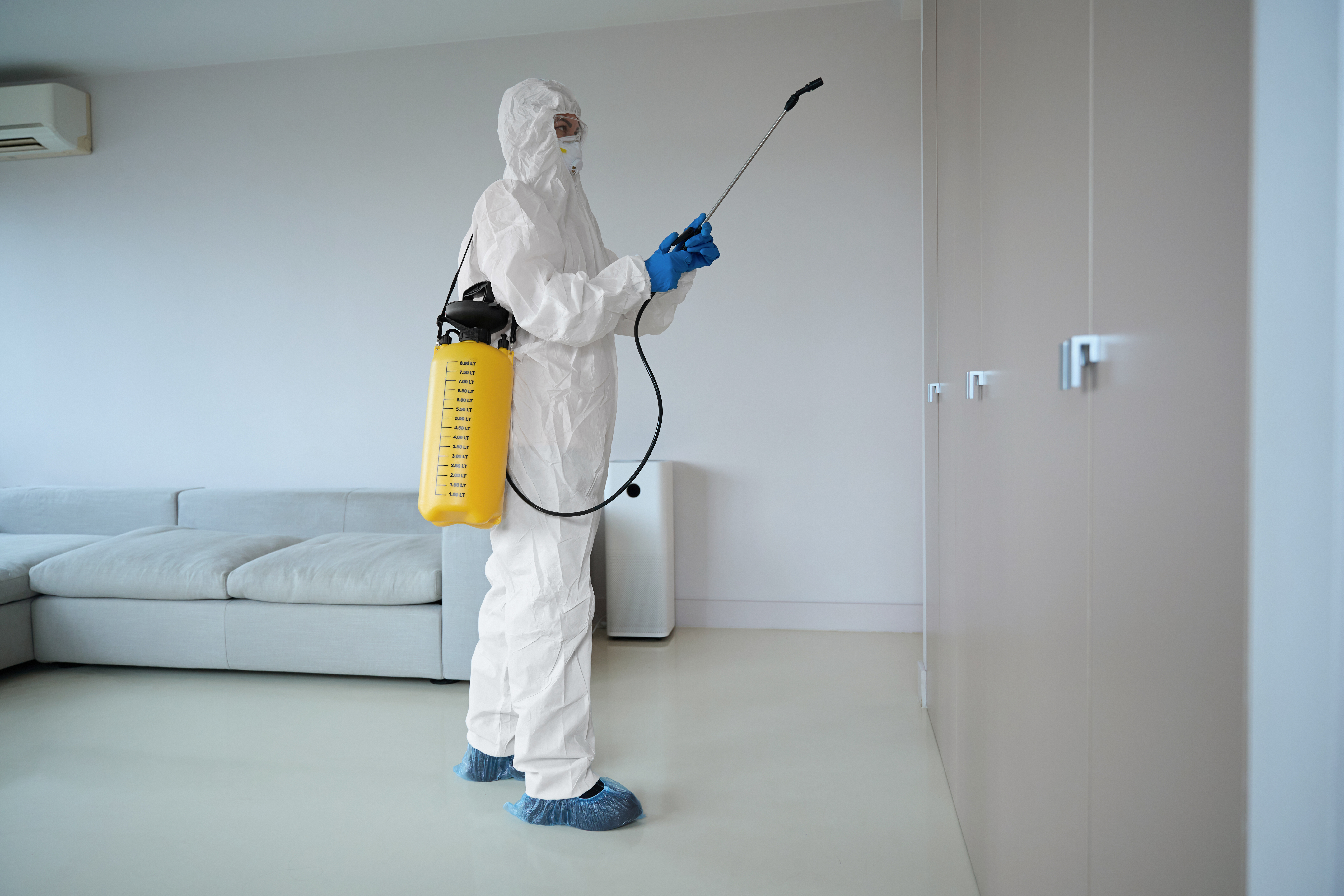 HomezGuard technician conducting a scheduled visit inside a residence.