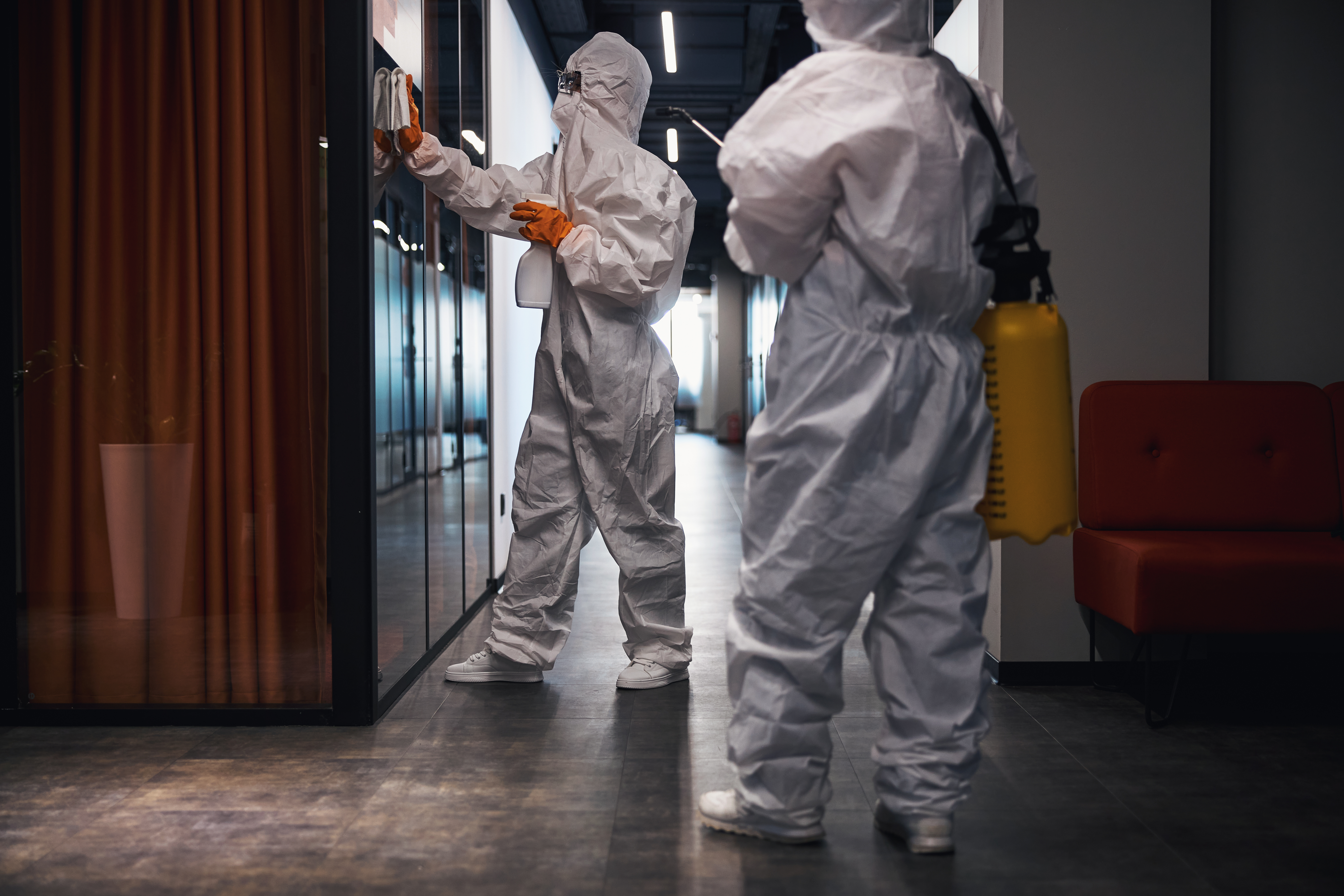 HomezGuard technicians at work in a commercial corridor.